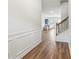 Inviting entryway boasting wood-look floors, white wainscoting, and a staircase leading to upper level at 814 Lakehaven Ln, Loganville, GA 30052