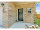 Close-up of the front entrance featuring a brick facade and a stylish black door at 814 Lakehaven Ln, Loganville, GA 30052