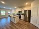 Contemporary kitchen featuring stainless steel appliances, white cabinets, and a center island at 814 Lakehaven Ln, Loganville, GA 30052