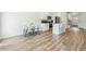 Open-concept kitchen and dining area with wood-look floors and modern appliances at 814 Lakehaven Ln, Loganville, GA 30052