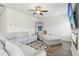 Bright living room with a large gray sofa, a mirror, and a TV over a fireplace at 814 Lakehaven Ln, Loganville, GA 30052