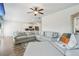 Bright living room with a large gray sofa and a TV over a fireplace at 814 Lakehaven Ln, Loganville, GA 30052