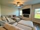 Spacious living room with a large sectional sofa, fireplace, and ample natural light at 814 Lakehaven Ln, Loganville, GA 30052