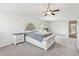 Large main bedroom featuring neutral walls, carpet flooring, a tray ceiling, and classic furniture at 814 Lakehaven Ln, Loganville, GA 30052