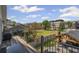 Deck view of a backyard with a pergola, outdoor kitchen and residential buildings across the street at 8175 Main St, Woodstock, GA 30188