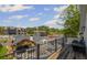 Deck view overlooking a backyard with a pool, outdoor kitchen, and covered patio seating area at 8175 Main St, Woodstock, GA 30188