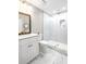 Bathroom featuring a glass shower with white tile, a marble floor, and a white vanity at 8175 Main St, Woodstock, GA 30188