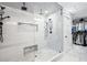 Modern bathroom featuring a glass shower with dual showerheads, a built-in seat, and a closet at 8175 Main St, Woodstock, GA 30188