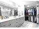 Elegant bathroom with double vanity, a glass enclosed shower, and a large closet at 8175 Main St, Woodstock, GA 30188