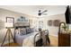 Bedroom with a metal frame queen-size bed, hardwood floors, and a view out of the window at 8175 Main St, Woodstock, GA 30188