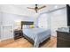 Cozy bedroom with a comfortable bed, hardwood floors, and ample closet space at 8175 Main St, Woodstock, GA 30188