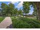 Community park with walking paths, benches, lush landscaping, and clock, providing a green space for leisure at 8175 Main St, Woodstock, GA 30188