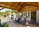This front porch has wicker chairs and a natural stone patio, and an inviting front door at 8175 Main St, Woodstock, GA 30188