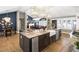 Spacious kitchen with a large island featuring a sink and dishwasher and stainless steel appliances at 8175 Main St, Woodstock, GA 30188