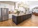 Modern kitchen features a large center island, stainless steel appliances, and sleek white cabinets at 8175 Main St, Woodstock, GA 30188