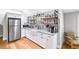 Kitchenette featuring modern stainless steel appliances, white cabinets, and granite countertops at 8175 Main St, Woodstock, GA 30188