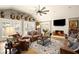 Spacious living room with fireplace, leather seating, and vaulted ceiling with deer mounts at 8175 Main St, Woodstock, GA 30188