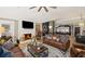 Inviting living room with a brick fireplace, hardwood floors, and stylish leather furniture at 8175 Main St, Woodstock, GA 30188