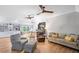 Spacious living room features hardwood floors, ceiling fans, and seating around the kitchen area at 8175 Main St, Woodstock, GA 30188