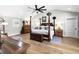 Bright main bedroom with hardwood floors, vaulted ceiling, and a four-poster bed at 8175 Main St, Woodstock, GA 30188