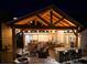 Outdoor kitchen featuring bar seating, stainless appliances, grill, and overhead lighting at 8175 Main St, Woodstock, GA 30188