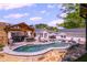 Backyard featuring a pool, outdoor kitchen, dining area, and lounge seating, designed for luxurious outdoor living at 8175 Main St, Woodstock, GA 30188