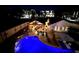 Night aerial view showcasing a pool and outdoor living space with a covered patio and lounge area at 8175 Main St, Woodstock, GA 30188