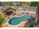 Aerial view of a backyard featuring a luxurious pool, covered patio, and ample lounge space at 8175 Main St, Woodstock, GA 30188
