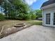 A patio and fire pit in a spacious backyard with mature trees at 9454 Lakeview Ct, Douglasville, GA 30135