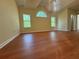 Large bedroom featuring vaulted ceilings, wood floors, and three windows providing lots of natural light at 9454 Lakeview Ct, Douglasville, GA 30135