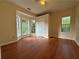 Bedroom with wood floors, neutral walls, and natural light from several windows at 9454 Lakeview Ct, Douglasville, GA 30135
