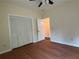 Comfortable bedroom with laminate floors and a closet with folding doors, creating a serene retreat at 9454 Lakeview Ct, Douglasville, GA 30135