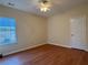 A bedroom with hardwood floors, ceiling fan, and natural light at 9454 Lakeview Ct, Douglasville, GA 30135