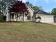 Charming home with manicured lawn, flowering trees, and attached two car garage at 9454 Lakeview Ct, Douglasville, GA 30135