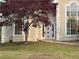 Front entrance of stucco home with an arched front door and manicured lawn at 9454 Lakeview Ct, Douglasville, GA 30135