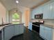 Kitchen featuring granite countertops, blue cabinets, and stainless steel appliances at 9454 Lakeview Ct, Douglasville, GA 30135