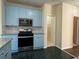 Stylish kitchen design with blue cabinets, stainless steel appliances, and easy access to pantry at 9454 Lakeview Ct, Douglasville, GA 30135