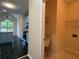 View of the kitchen leading to a separate laundry room with a utility sink and shelving at 9454 Lakeview Ct, Douglasville, GA 30135