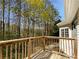 Exterior view of deck overlooking wooded yard on a sunny day at 105 Laurel Ridge Ct, Fayetteville, GA 30215