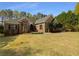 Beautiful brick home with lush landscaping and a well-kept front lawn at 105 Laurel Ridge Ct, Fayetteville, GA 30215