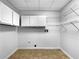 Utility room featuring hookups for a washer and dryer with white cabinets and wire shelves at 105 Laurel Ridge Ct, Fayetteville, GA 30215