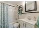 Bright bathroom includes a shower with a leaf-patterned curtain, and a sleek vanity at 1325 East Forrest Ave, East Point, GA 30344