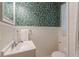 Charming half-bathroom with floral wallpaper, beadboard wainscoting, and a classic vanity at 1325 East Forrest Ave, East Point, GA 30344