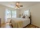 Comfortable bedroom featuring a ceiling fan, natural light from two windows, and hardwood floors at 1325 East Forrest Ave, East Point, GA 30344