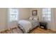 Inviting bedroom with two bright windows, wood floors, and a patterned bedspread at 1325 East Forrest Ave, East Point, GA 30344