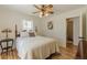 Cozy bedroom boasts a wood frame bed, ceiling fan, and access to an adjoining bathroom at 1325 East Forrest Ave, East Point, GA 30344