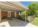 Covered carport featuring concrete slab, chain-link fence and small plants at 1325 East Forrest Ave, East Point, GA 30344
