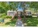 Beautiful home showcasing a pathway, green lawn and mature tree at 1325 East Forrest Ave, East Point, GA 30344