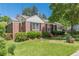 Charming brick home featuring well-manicured lawn and mature landscaping at 1325 East Forrest Ave, East Point, GA 30344