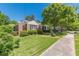 Well-maintained home with lush lawn, sidewalk, and mature shade tree at 1325 East Forrest Ave, East Point, GA 30344